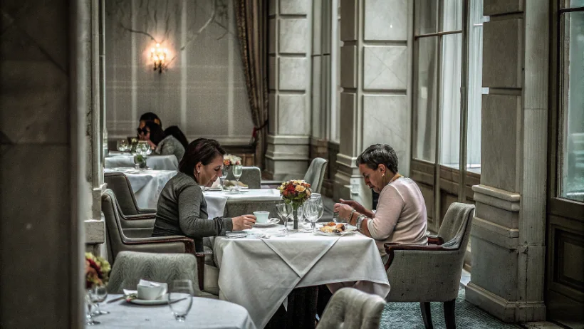 Diners enjoying fine dining experience at upscale restaurant